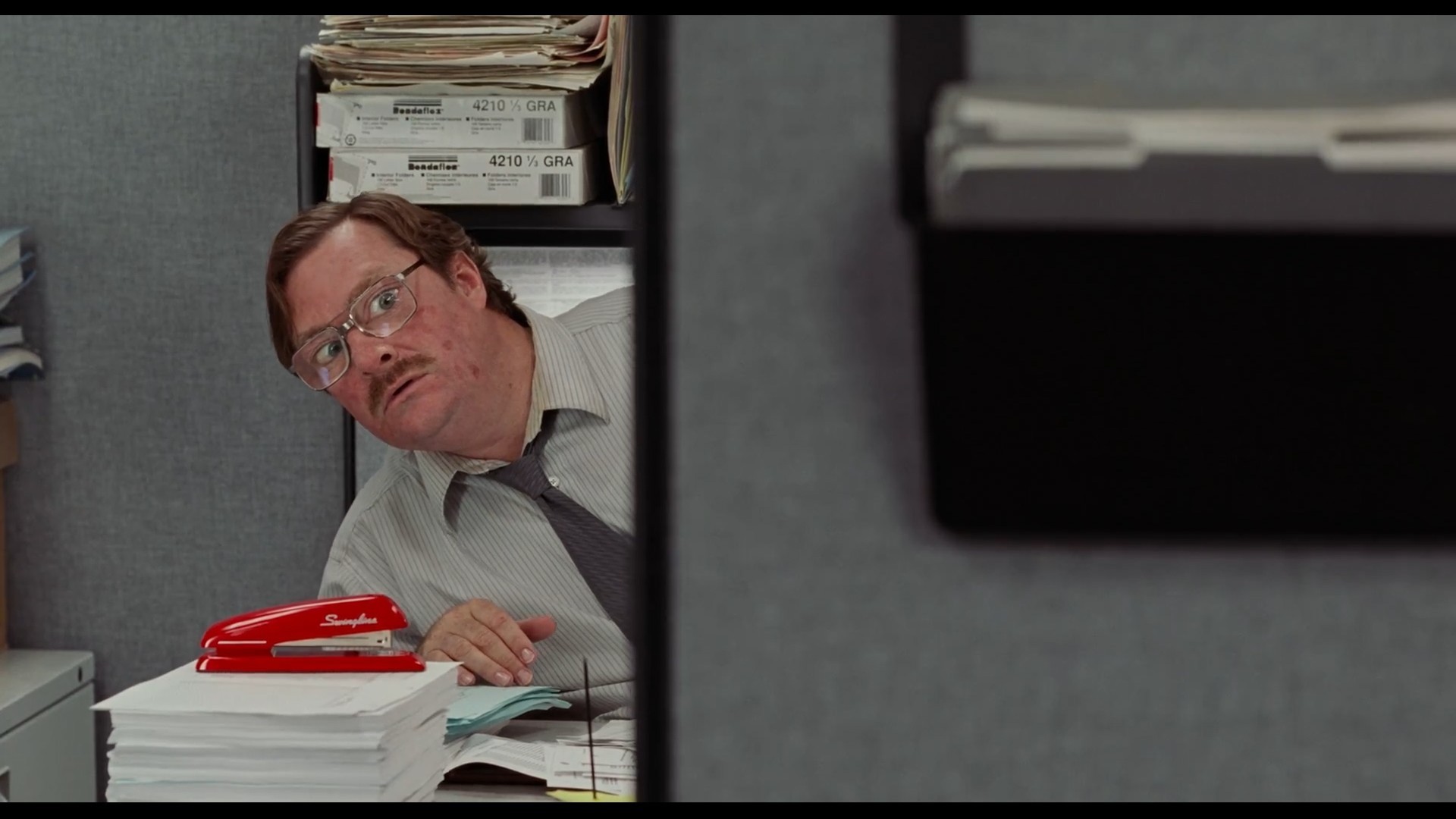 Screenshot of Office Space, Milton and stapler at 00:32:56