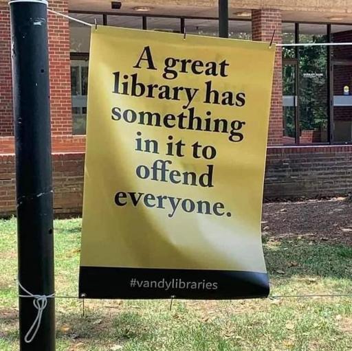 A yellow hung up sign, probably outside a library that says:
A great Iibrary has something in it to offend everyone.
#VandyLibrary