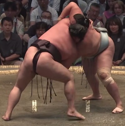 two sumo wrestlers grappling