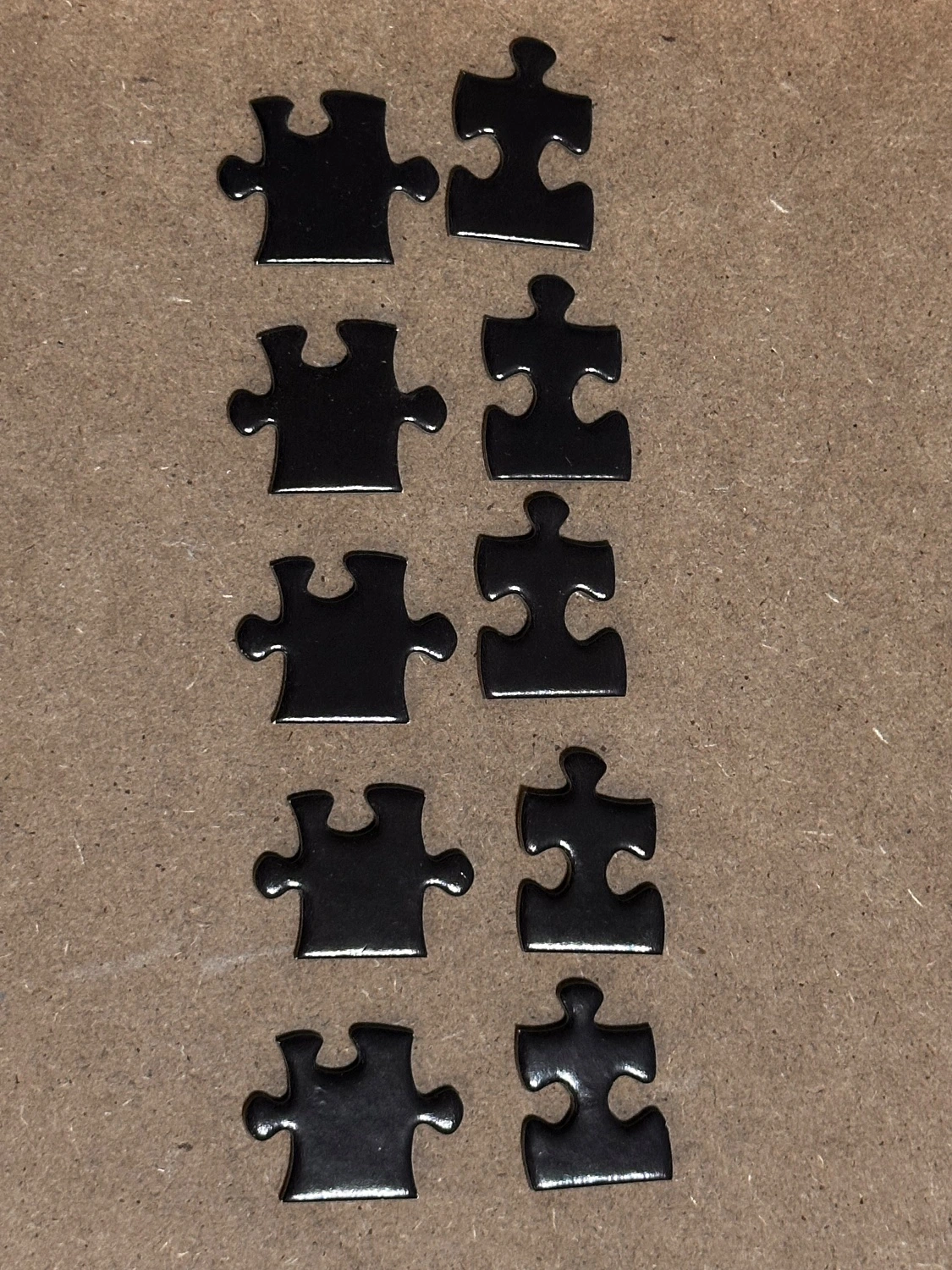 Photo showing two sets of 5 puzzle pieces with identical coloring and *nearly* identical shape