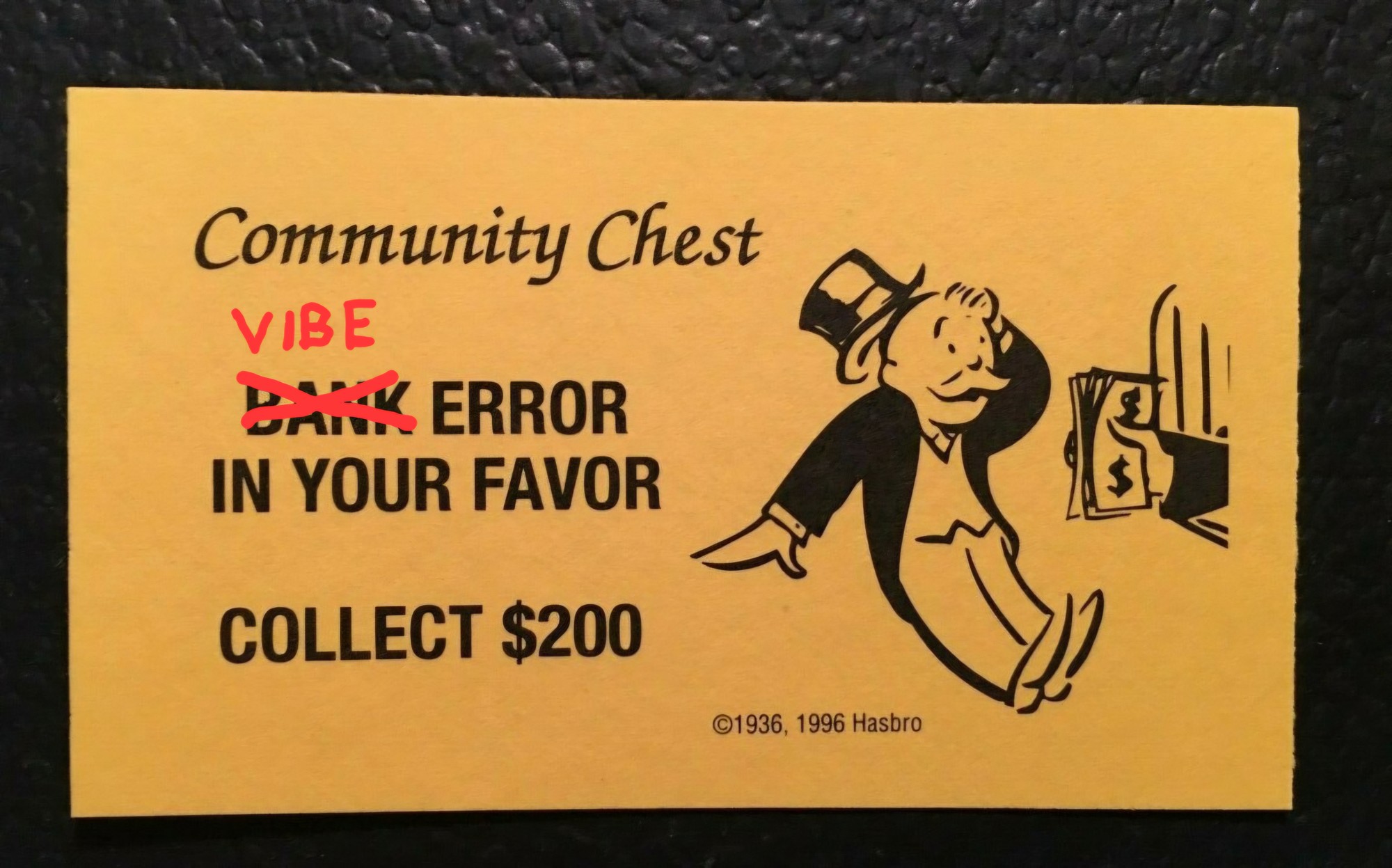 "BANK ERROR IN YOUR FAVOR COLLECT $200" Monopoly Community Card. Bank is crossed off and a replaced with Vibe