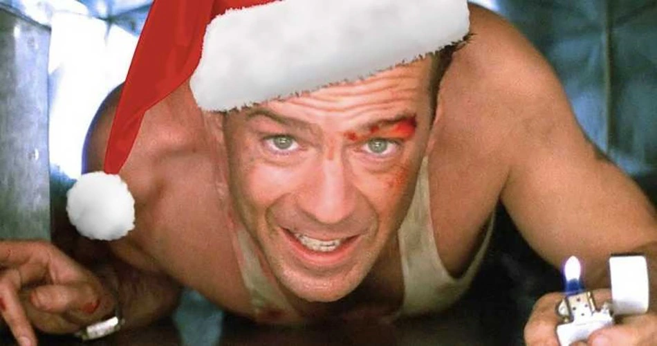 John McLane crawling through an airduct, with a Zippo for light and a Santa hat photoshopped onto his head
