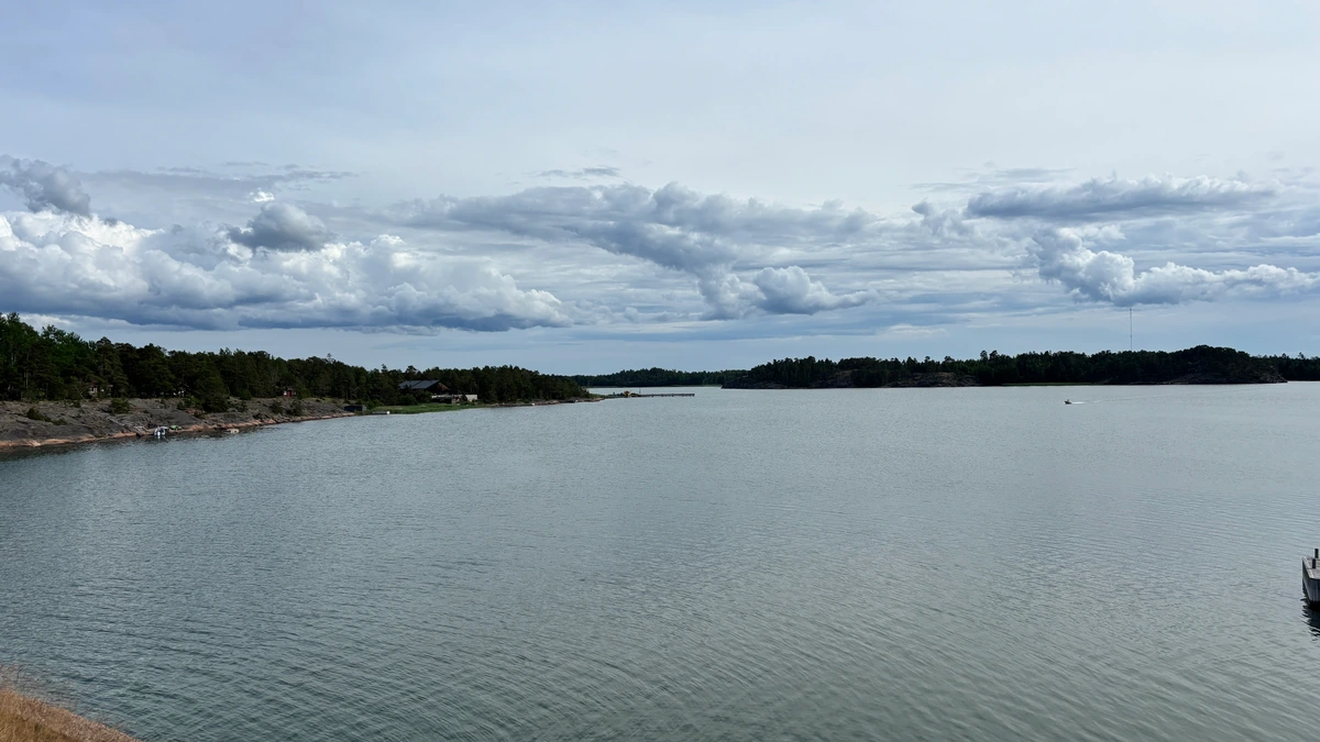 Photo of mostly water and sky with cloud formations that look like something from an oil painting.
