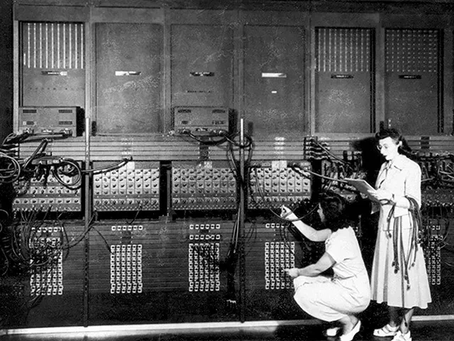 Marlyn Wescoff (standing) and Ruth Lichterman reprogram the ENIAC supercomputer, USA, 1946