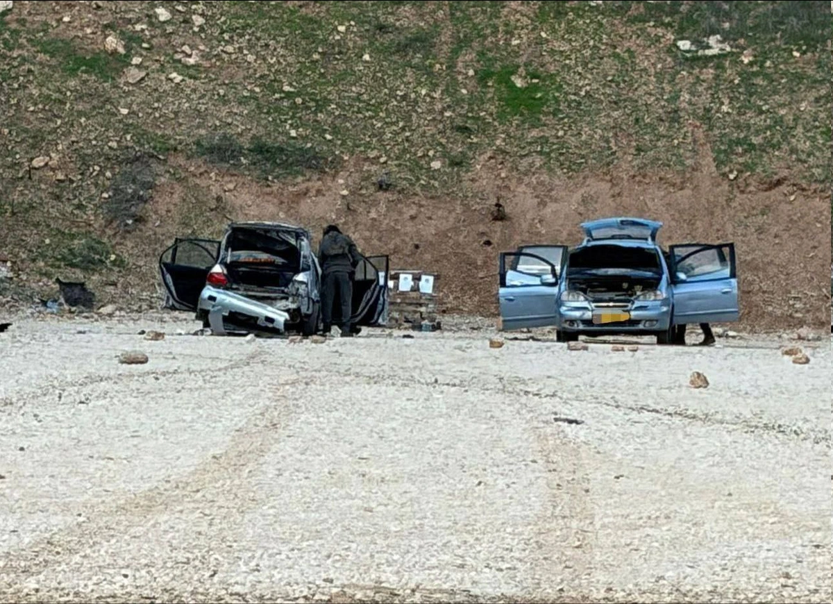 picture of 2 damaged cars on the side of the road