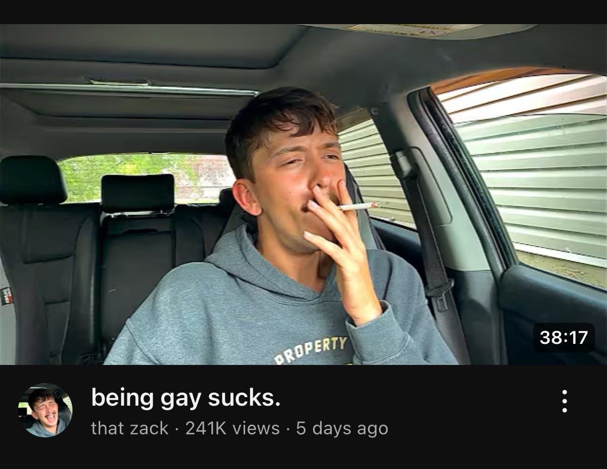 Screenshot of YouTube video titled “being gay sucks.” with a young gay man smoking a cigarette in his car