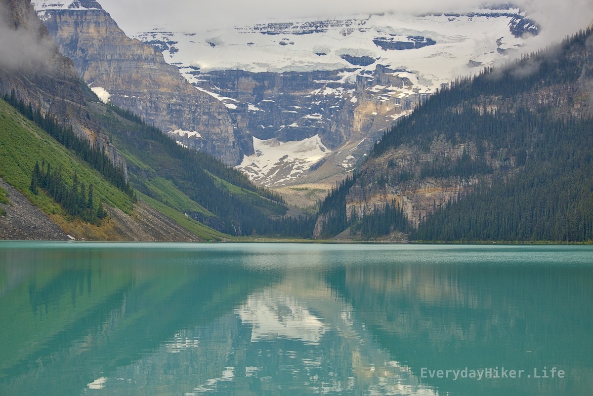 The view across Lake Louise from it’s western shore.  Mount Victoria may be seen on the opposite side, with a large chunk of snow still waiting to break free.
