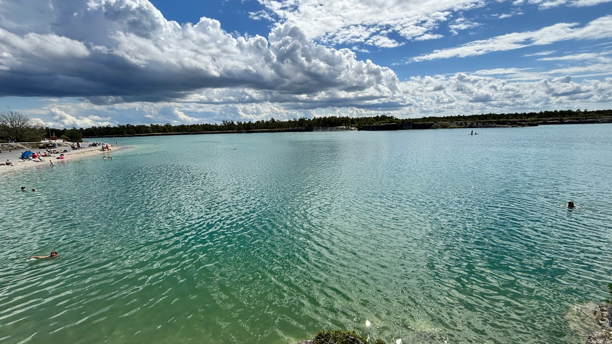 Photo of an old lime works filled with water where people can swim.