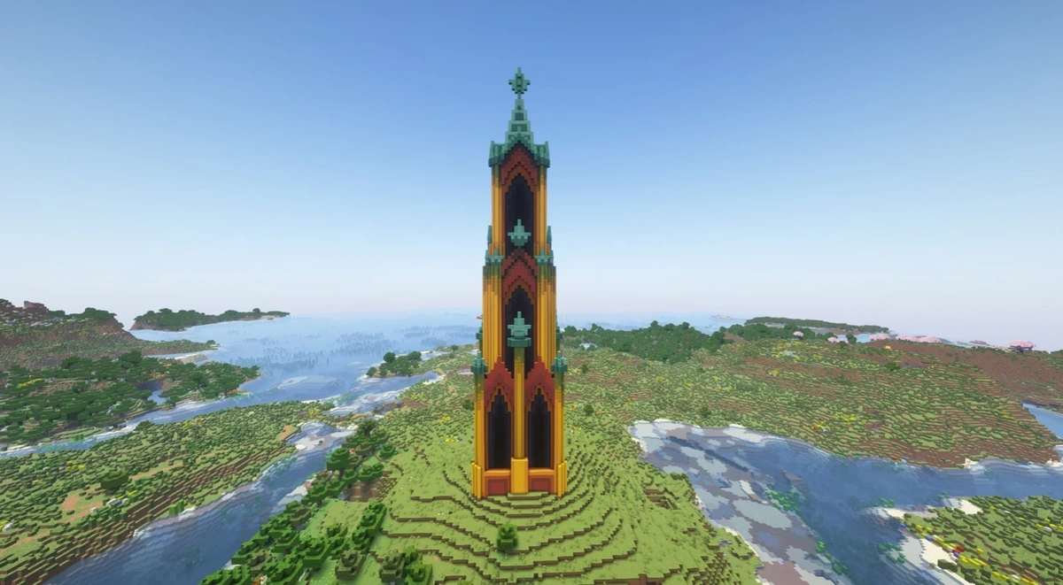 A minecraft screenshot of a large scale, gothic-style tower. The tower itself is made of bright yellows, reds, and turquoise. It stands alone in a field with a river going past it