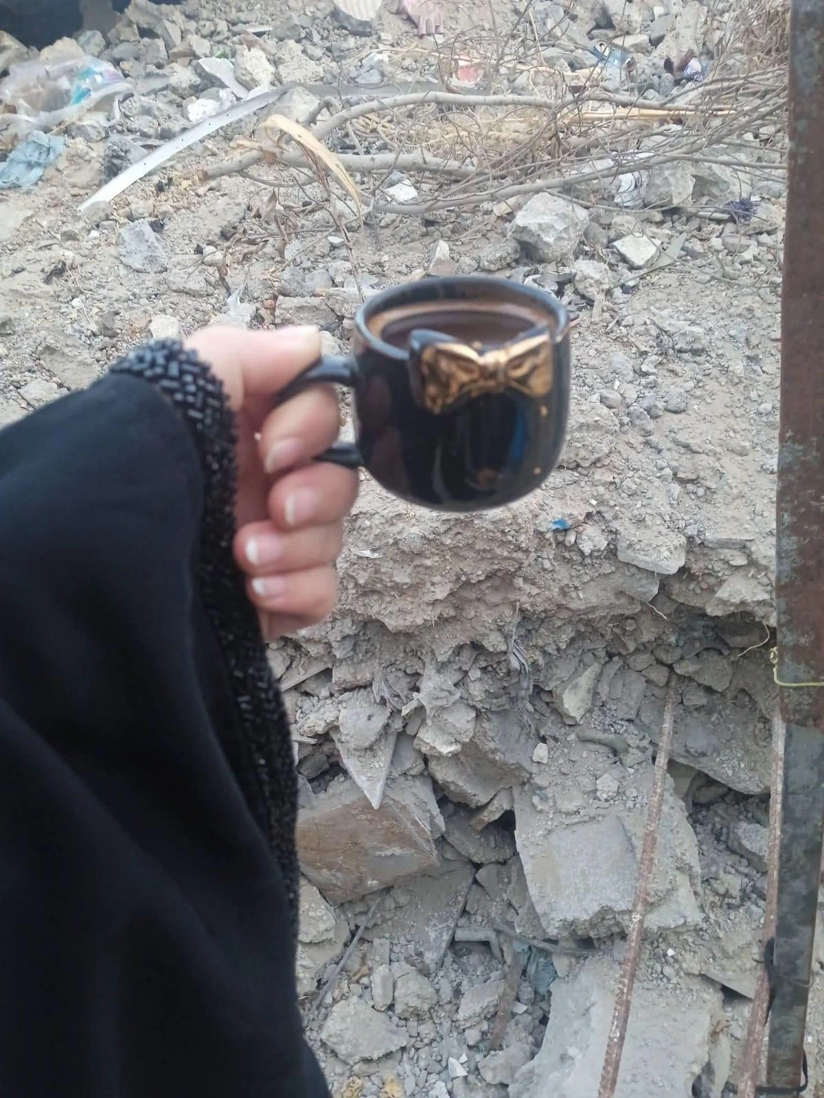 Coffee in front of the rubble of my home.