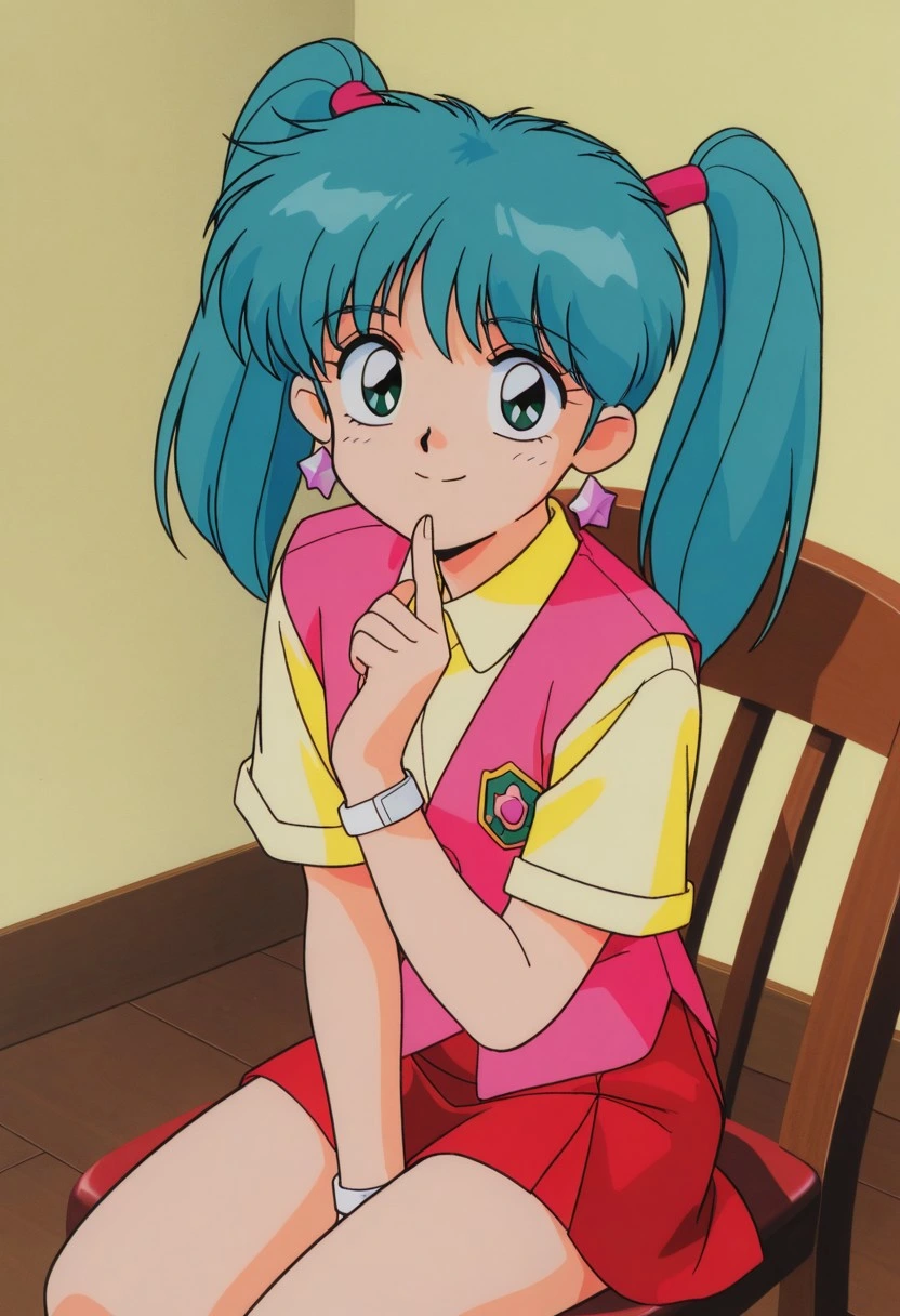 A smiling girl with green eyes and bright turquoise hair tied up into two high pigtails with pink bands sitting in a wooden chair with her right index finger raised and touching her lower lip. She is wearing a yellow collared shirt with short sleeves and a pink vest featuring a green and pink shield-shaped emblem, a red skirt, pink star-shaped earrings, and white wristbands. She is indoors in front of a solid, light yellow wall with a darker brown floor.