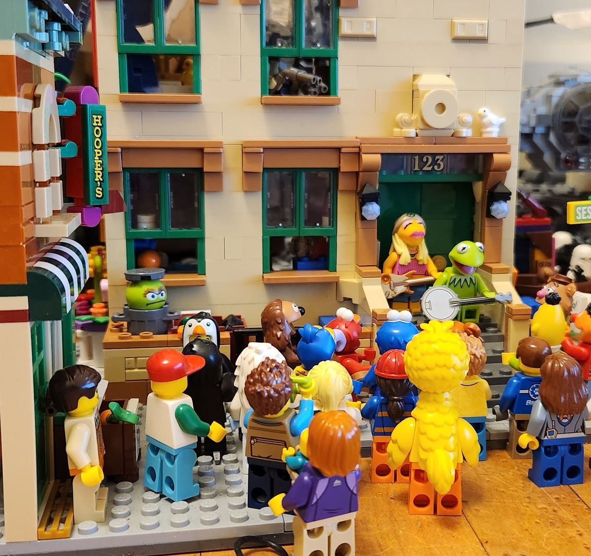 A couple of the muppets jamming in front of Sesame Street characters. 