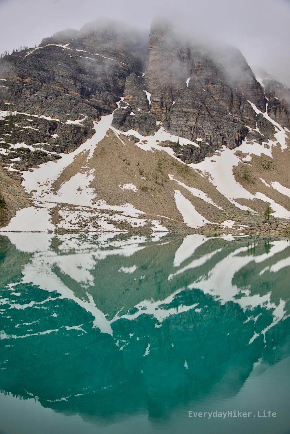 The Devil's Thumb pokes it's way into the clouds while the still waters of Lake Agnes reflect a thumbs down.