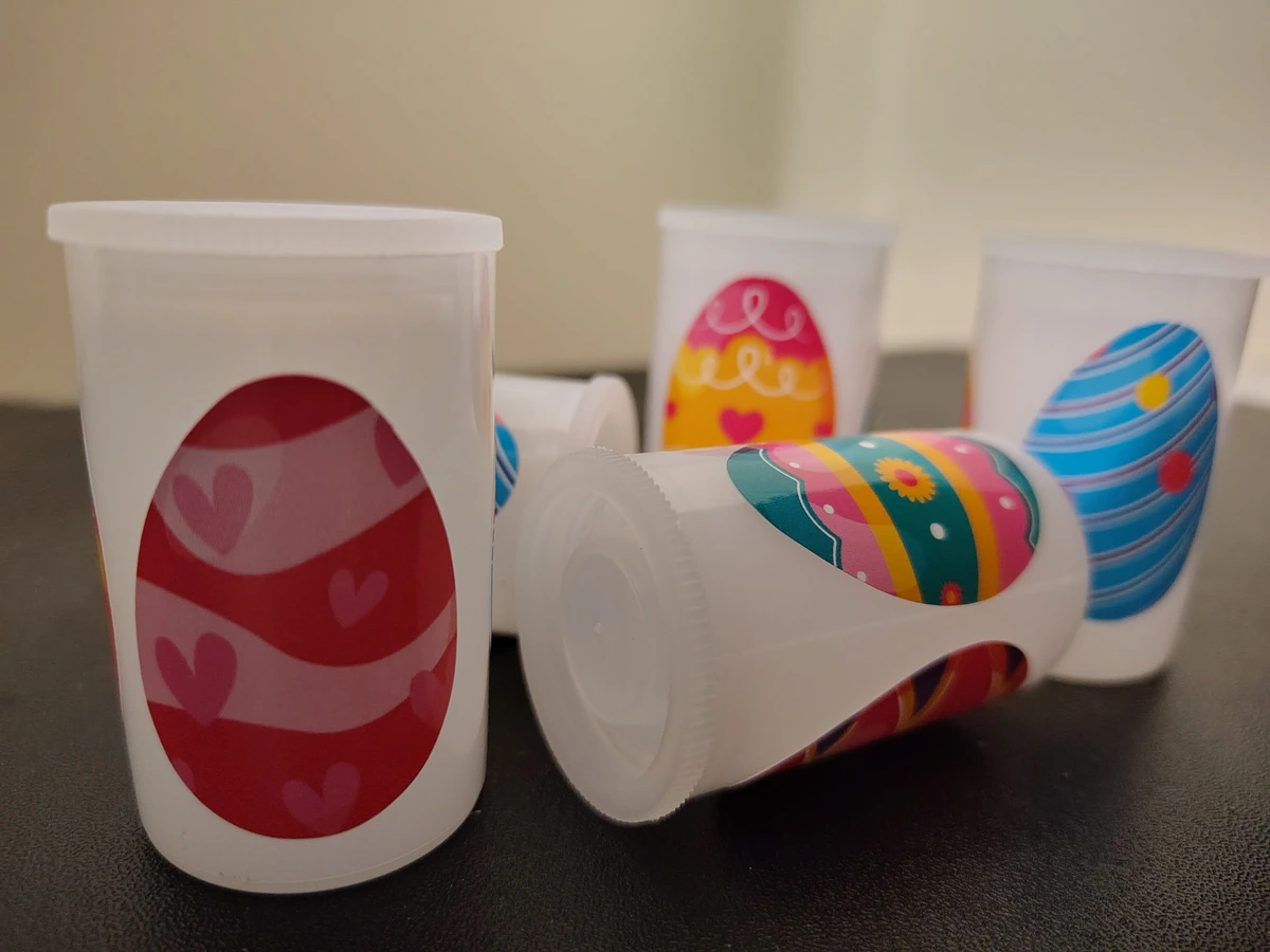 Five film canisters with easter egg stickers on