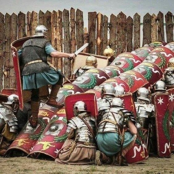 Re-enactors in full kit showing use of a 1st-2nd century AD Roman Testudo formation to allow troops to mount a wall