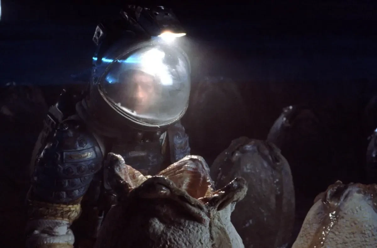Scene from the film 'Alien' - alien egg opening in front of man in space suit
