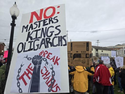 picture of a protest poster that says "no: masters kings oligarchs" and a photo of a fist grabbing and breaking a chain with "break the chains" stylized behind it