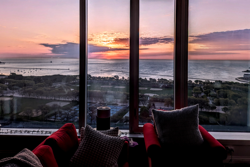 an early sunrise around 05:30ish, framed through a living room view, in Chicago
