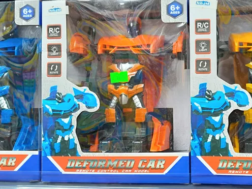 A shop shelf, with a rip-off cheap toy, based loosely on the Transformers cartoon. The toy is called "Deformed Car".